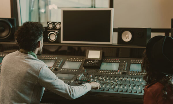 sound producers looking at blank monitor at recording studio